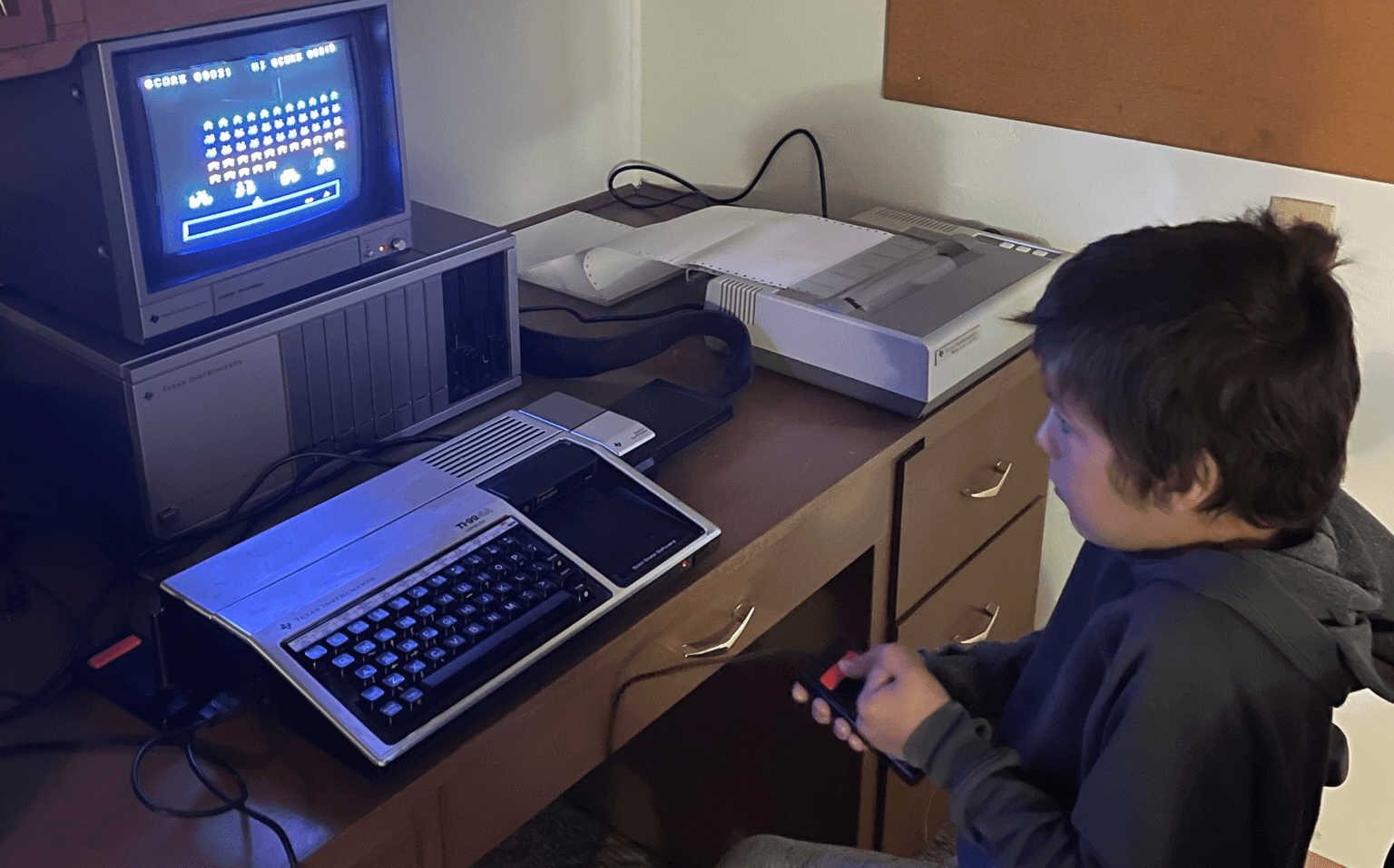 Isaac Abbott playing TI Invaders on my TI-99/4A